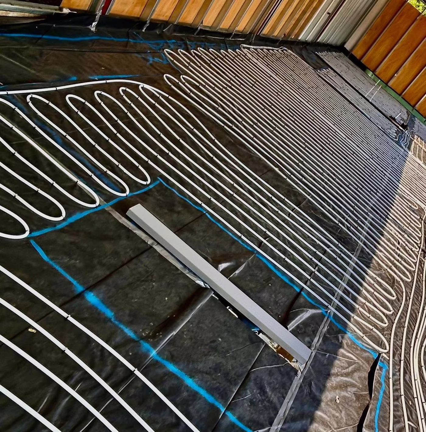 Close view of underfloor heating pipe clipped down in tight loops ready for screed
